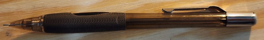 A closeup photo of the clear barrel of the Pentel Quicker Clicker mechanical pencil.