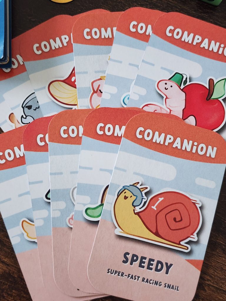 A spread of Companion cards, each depicting a cartoon-ish entity, that acts as a companion to a goblin. Companions such as Speedy the Super-Fast Racing Snail, Buzzy the Busy Little Bee friend, and Wispy the Elemental Spirit friend.